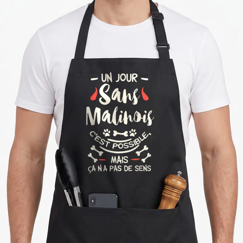 Tablier de cuisine noir avec inscription Un jour sans Malinois et illustrations d'os et de pattes de chien.