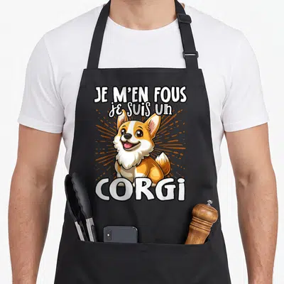 Tablier de cuisine noir avec illustration d'un corgi souriant et texte Je m'en fous je suis un Corgi en blanc.