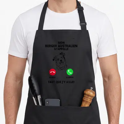 Tablier de cuisine noir avec illustration tête chien et boutons téléphone rouge et vert appelant un Berger Australien.