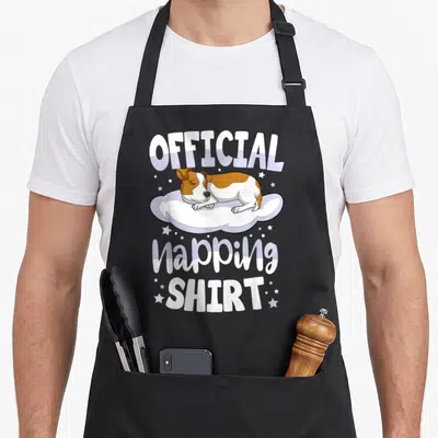 Tablier de cuisine noir avec illustration d'un Jack Russell Terrier dormant sur un nuage et le texte Official Napping Shirt en blanc et violet.
