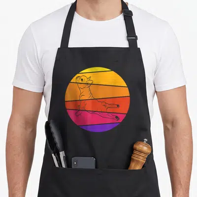 Tablier de cuisine noir avec illustration d'un bouledogue français en yoga sur fond circulaire coloré style rétro.