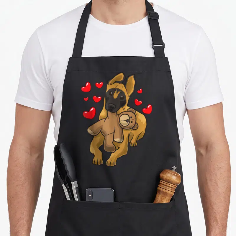 Tablier de cuisine noir avec illustration d'un chien malinois tenant une ours en peluche et des cœurs rouges flottants autour de lui.