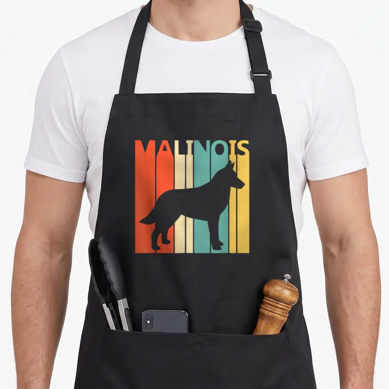 Tablier de cuisine noir avec silhouette de chien Malinois sur fond de bandes verticales orange, crème, turquoise et jaune.