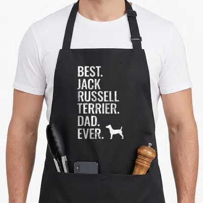 Tablier de cuisine noir avec l'inscription Best Jack Russell Terrier Dad Ever et une silhouette de chien blanche en bas à droite.