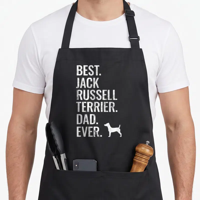 Tablier de cuisine noir avec l'inscription Best Jack Russell Terrier Dad Ever et une silhouette de chien blanche en bas à droite.
