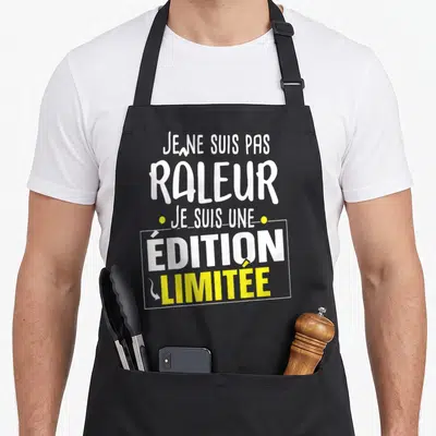 Tablier de cuisine noir avec l'inscription blanche et jaune Je ne suis pas râleur je suis une « édition limitée ».