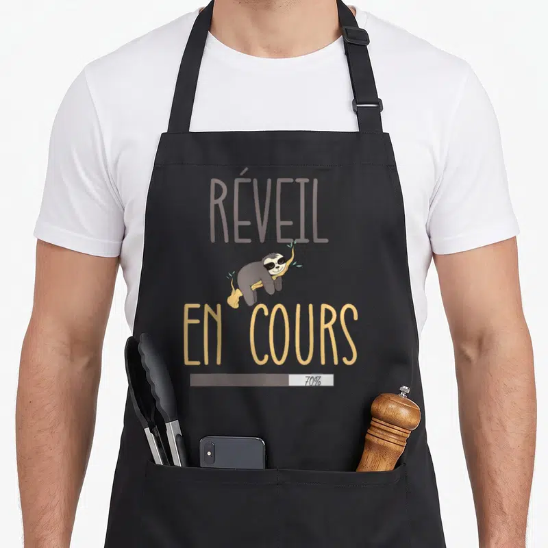 Tablier de cuisine noir avec illustration de fourmi portant des lunettes de soleil et le texte Réveil en cours 70%