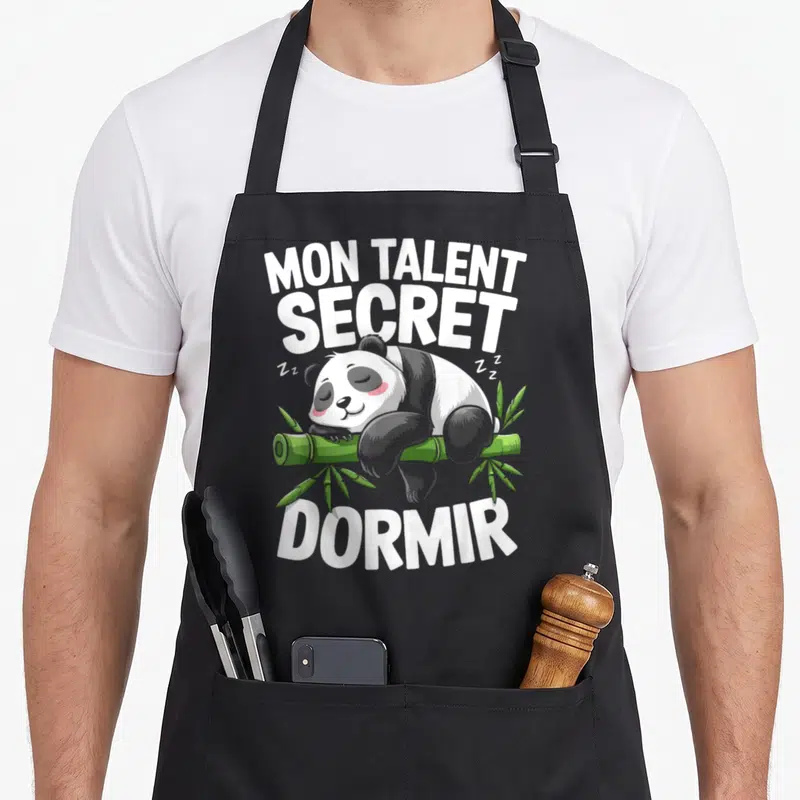 Tablier de cuisine noir avec illustration d'un panda dormant sur du bambou et le texte Mon Talent Secret Dormir en blanc.
