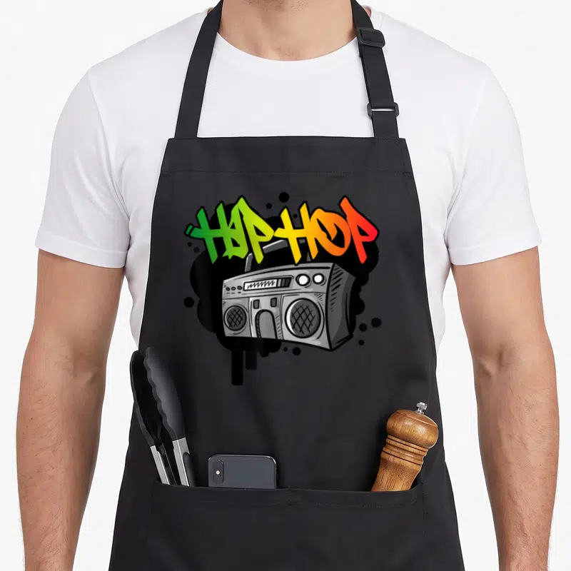 Tablier de cuisine noir avec illustration de boombox et texte Hip Hop en style graffiti multicolore.