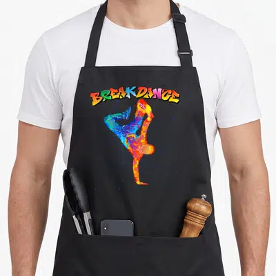 Tablier de cuisine noir avec illustration multicolore d'un danseur en pose de breakdance et texte BREAKDANCE en style graffiti.