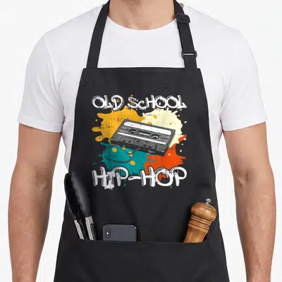 Tablier de cuisine noir avec illustration cassette Old School Hip Hop et éclaboussures de couleurs vives.