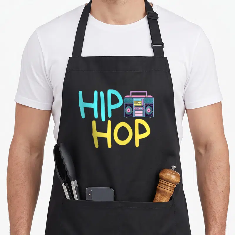 Tablier de cuisine noir avec une illustration de boombox et le texte HIP HOP en couleurs vives.