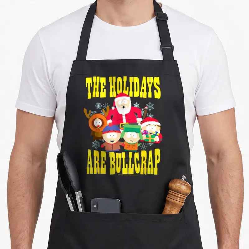 Tablier de cuisine noir avec les personnages de South Park et le texte The Holidays Are Bullcrap en jaune vif.