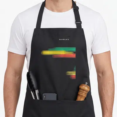 Tablier de cuisine noir avec inscription Marley et motifs colorés vert jaune rouge style éclaboussure horizontale.