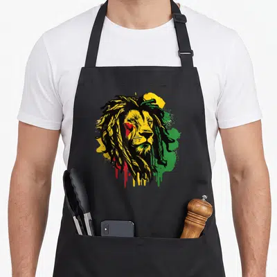 Tablier de cuisine noir avec tête de lion aux cheveux dreadlocks et couleurs Rasta jaune vert rouge