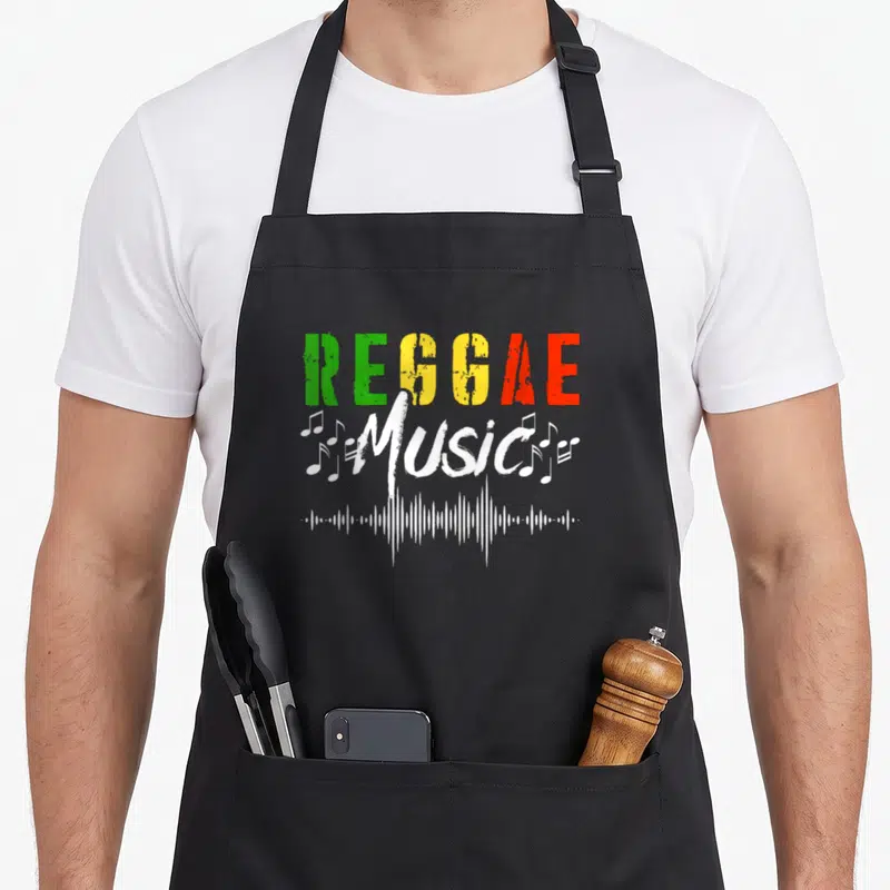 Tablier de cuisine noir avec inscription Reggae Music aux couleurs vert jaune rouge et ondes sonores blanches.