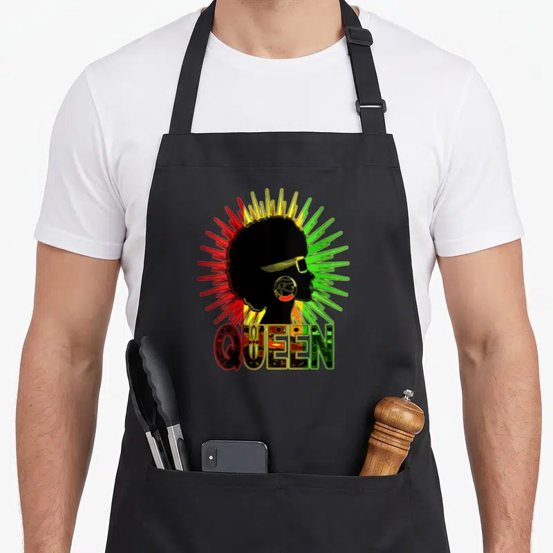 Tablier de cuisine noir avec silhouette Queen Rasta aux cheveux afro et texte coloré