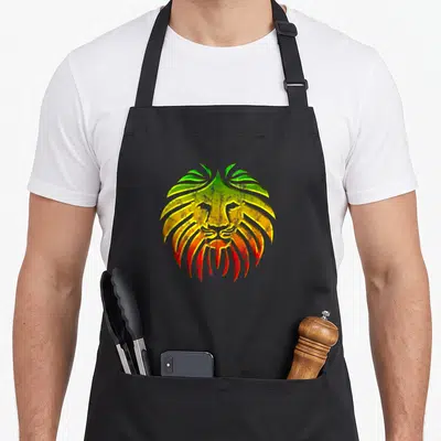 Tablier de cuisine noir avec illustration d'un lion aux cheveux stylisés verts jaunes et rouges dans un style vintage.