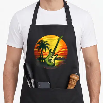 Tablier de cuisine noir avec une guitare verte, des palmiers et un soleil couchant aux couleurs Rasta.