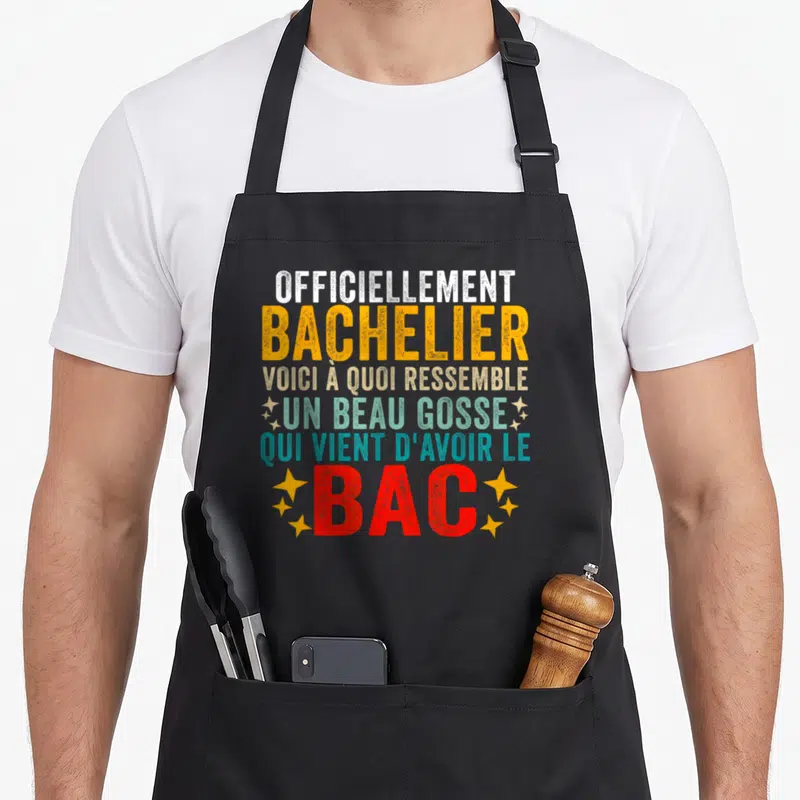 Tablier de cuisine noir avec typographie colorée mentionnant bachelier et beau gosse bac 2026