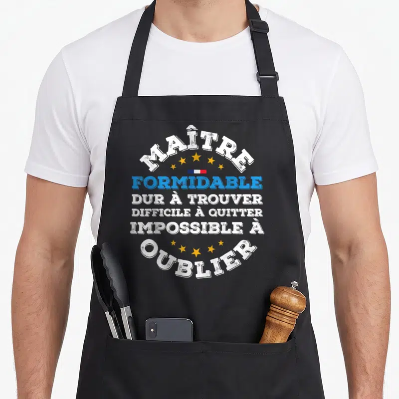Tablier de cuisine noir avec inscription blanche et bleue Maître formidable entouré d'étoiles dorées et d'un petit drapeau français.