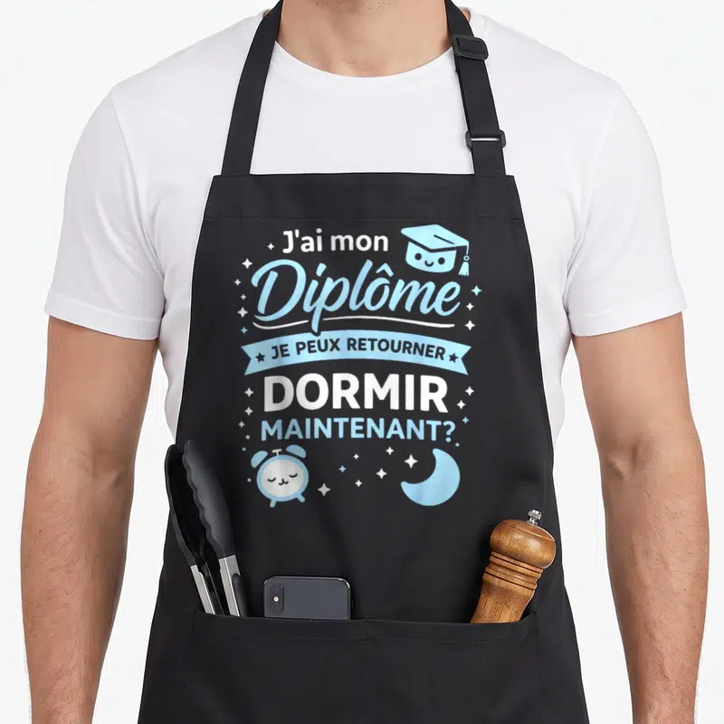 Tablier de cuisine noir avec inscription J'ai mon Diplôme et illustration d'alarme endormie bleue.