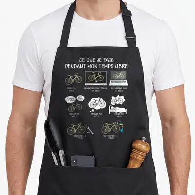 Tablier de cuisine noir avec des illustrations de vélos et du texte sur les activités de cycliste en temps libre.