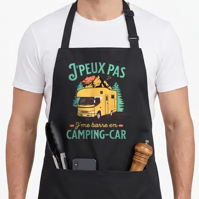 Tablier de cuisine noir avec illustration camping-car jaune, montagnes et texte Jpeuxpas Camping-car