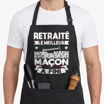 Tablier de cuisine noir avec inscription Le meilleur maçon a fini et illustration de marteau et briques blanches.