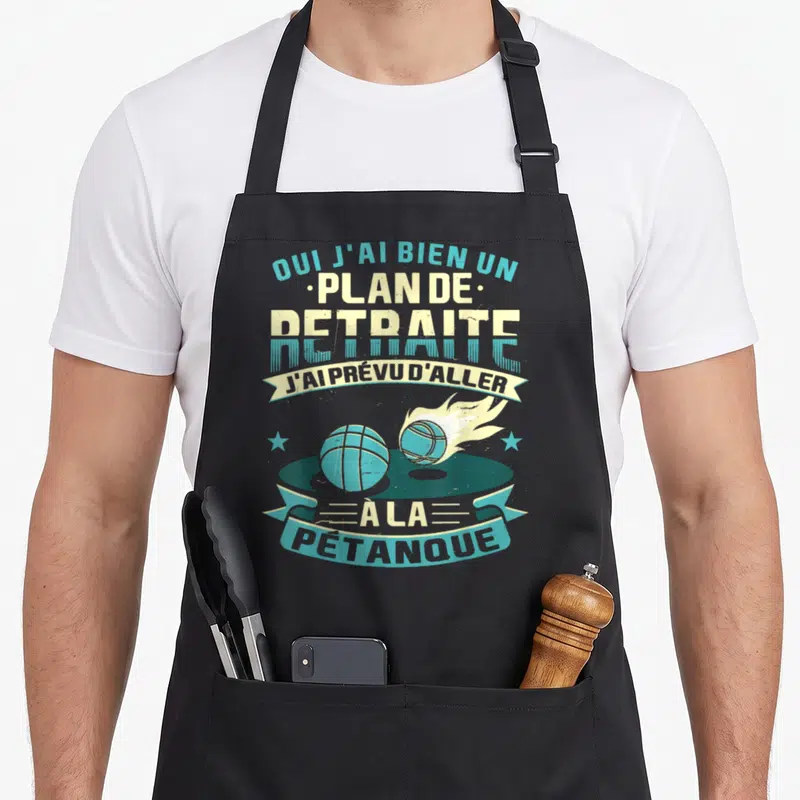 Tablier de cuisine noir avec illustration vintage de boules de pétanque et texte sur le plan de retraite.