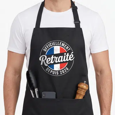 Tablier de cuisine noir avec un logo circulaire aux couleurs du drapeau français et le texte « Officiellement Retraité Depuis 2026 » en blanc.