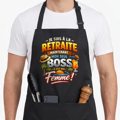 Tablier de cuisine noir avec inscription humoristique sur le thème de la retraite et des vacances tropicales.