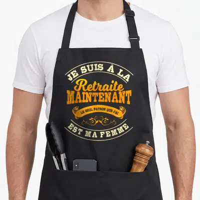 Tablier de cuisine noir avec inscription Je suis à la retraite maintenant et le seul patron que j'ai est ma femme en orange et crème.