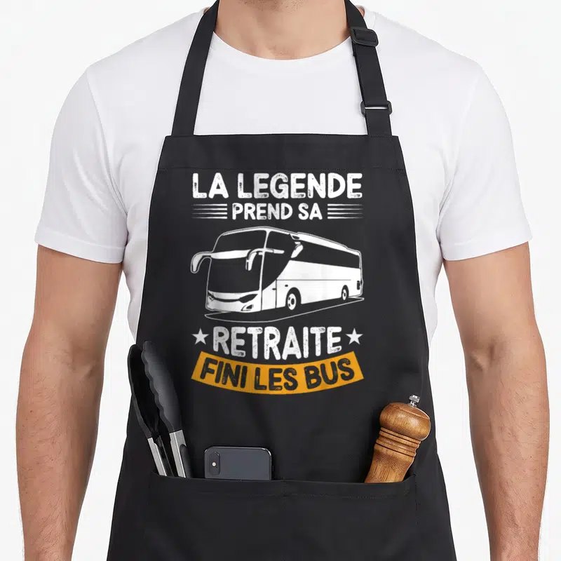 Tablier de cuisine noir avec autocar blanc et texte La légende prend sa retraite fini les bus sur fond orange.
