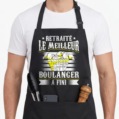 Tablier de cuisine noir avec corbeille de croissants et texte Le meilleur boulanger a fini en blanc et jaune.