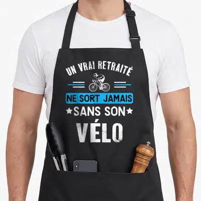 Tablier de cuisine noir avec un vrai retraité ne sort jamais sans son vélo et silhouette cycliste blanche.