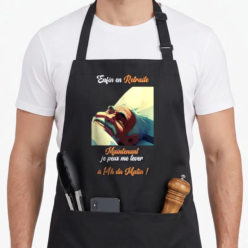 Tablier de cuisine noir avec illustration d'un homme dormant et texte enfin en retraite maintenant je peux me lever à 14h du matin