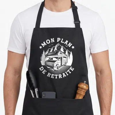 Tablier de cuisine noir avec illustration camping-car et texte Mon Plan De Retraite en blanc.