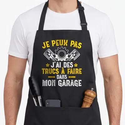 Tablier de cuisine noir avec inscription Je peux pas j'ai des trucs à faire dans mon garage et illustration de pistons mécaniques.