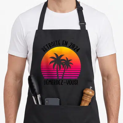 Tablier de cuisine noir avec soleil rétro rose et palmiers gris portant l'inscription Retraité en 2024 Démerdez-vous.