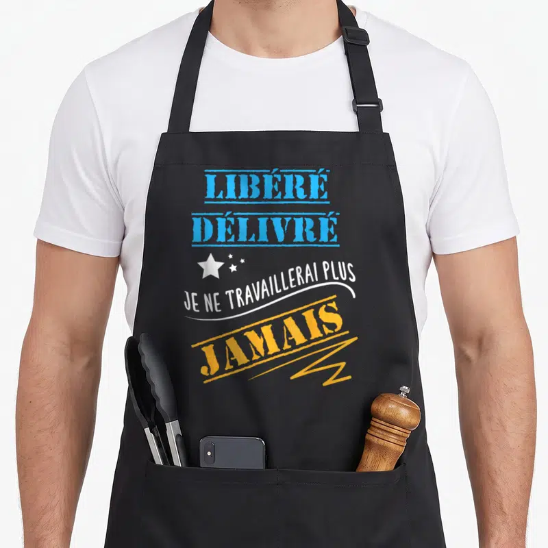 Tablier de cuisine noir avec inscription libéré délivré je ne travaillerai plus jamais en bleu et jaune.
