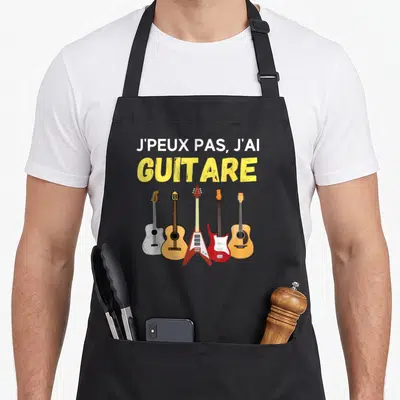 Tablier de cuisine noir avec inscription J'peux pas j'ai guitare et cinq illustrations d'instruments colorés alignés en bas.