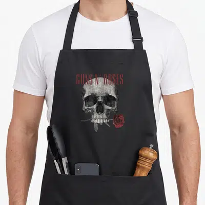 Tablier de cuisine noir avec un crâne tenant une rose rouge et le texte Guns N' Roses en rouge.
