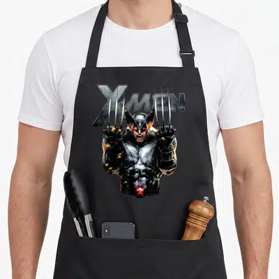 Tablier de cuisine noir avec un personnage aux griffes sortantes et le logo X-Men en lettres métalliques.