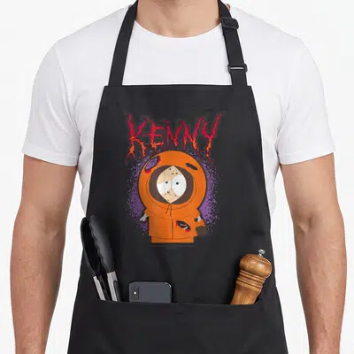 Tablier de cuisine noir avec illustration orange de Kenny aux yeux écarquillés et nom en lettres rouillées rouges au-dessus.