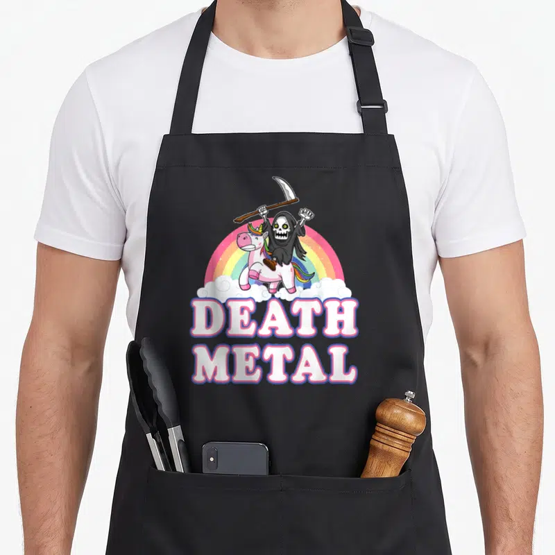 Tablier de cuisine noir avec illustration de la Mort chevauchant une licorne rose sur arc-en-ciel et texte Death Metal.