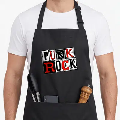 Tablier de cuisine noir avec l'inscription Punk Rock en lettres rouges et noires sur fond blanc cassé style collage vintage.