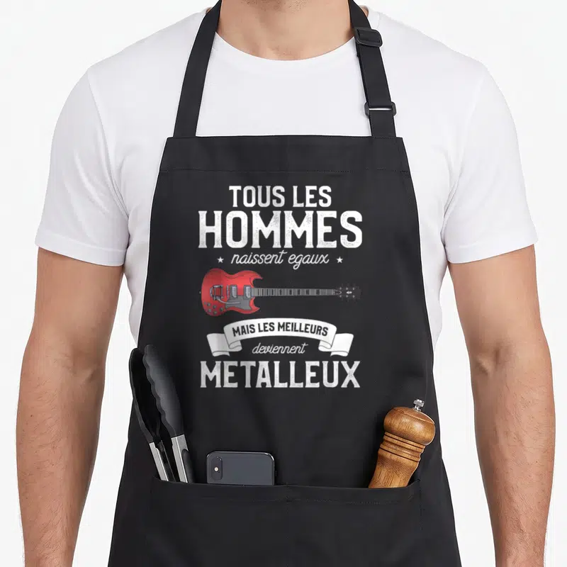 Tablier de cuisine noir avec une guitare électrique rouge et le texte Tous les hommes naissent égaux mais les meilleurs deviennent métalleux.