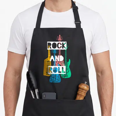 Tablier de cuisine noir avec Rock and Roll et trois guitares jaunes, bleues et vertes superposées.