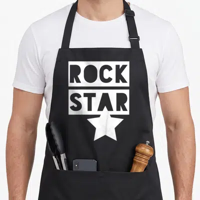 Tablier de cuisine noir avec inscription Rock Star en blanc et une grande étoile stylisée sous le texte.